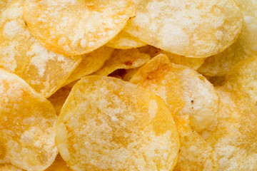 Close up potato chips on wood top view background.