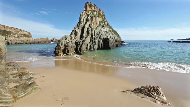 Atlantic Ocean summer coast view from sandy Mexota beach and pointed rock (Spain). 
