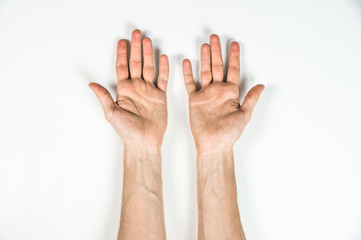 Top view of hands of man on white table. Palms of a male person shot from top view with natural...