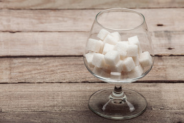 The cognac glass with refined sugar.