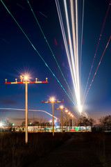Fototapeta na wymiar The light trails of approaching aircraft to Frankfurt´s runway 07L during the evening rush.