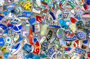 Wall with broken ceramic plates colored fragments