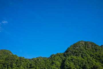 Blue sky over green mountain