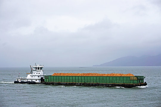 Pusher Tug And Barge Going Up The Columbia River In Astoria Oregon