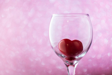 red heart in a glass on  blurred background. 