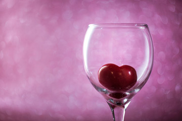 red heart in a glass on  blurred background. 