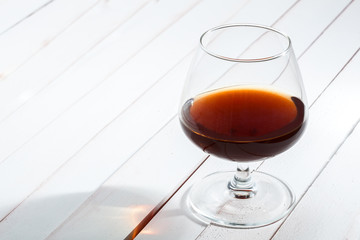 Glass for whisky on wooden table.