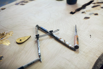 High angle view of drafting compass on wooden plank at workshop