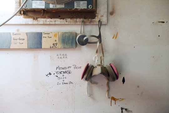 Protective equipment hanging on wall in workshop