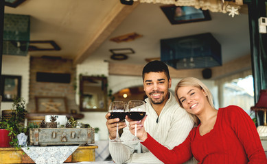 Lovely multiracial couple drinking wine at restaurant.