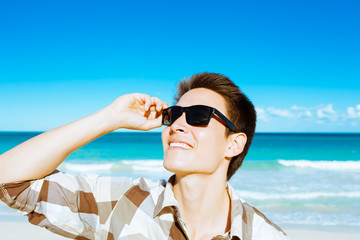 Happy male enjoying a sunny day at the beach. 