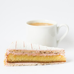 Zuger Kirschtorte. Piece of cake and a cup of black coffee. Isolated on white background. Selective focus.