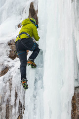 Ice Climber in green jacket with ice axe