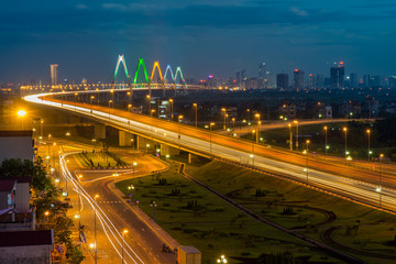 Hanoi skyline at twilight at Vo Chi Cong street, leading to Nhat Tan cable-stayed bridge, Dong Anh district
