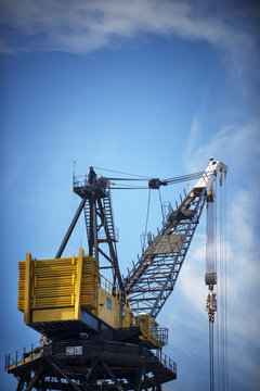 Low angle view of crane against blue sky