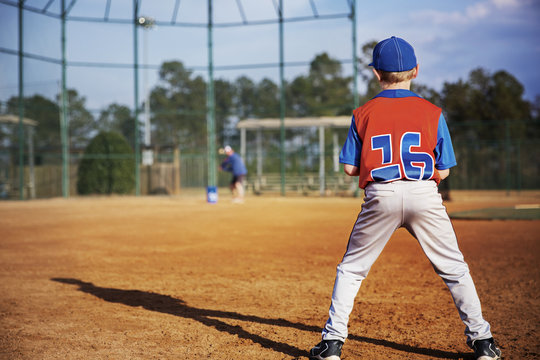 Boy playing baseball on field