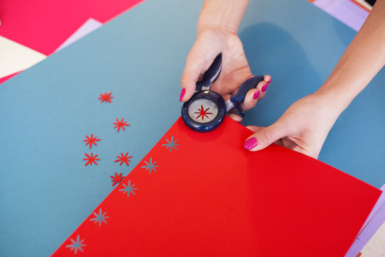Young woman make scrapbook of the papers on the table using anti