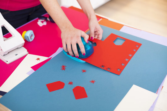 Young woman make scrapbook of the papers on the table using anti