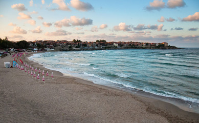 Beautiful coast of the Black Sea in Bulgaria, in the resort town of Sozopol. Seaside. A silhouette of a seaside city in the setting sun.