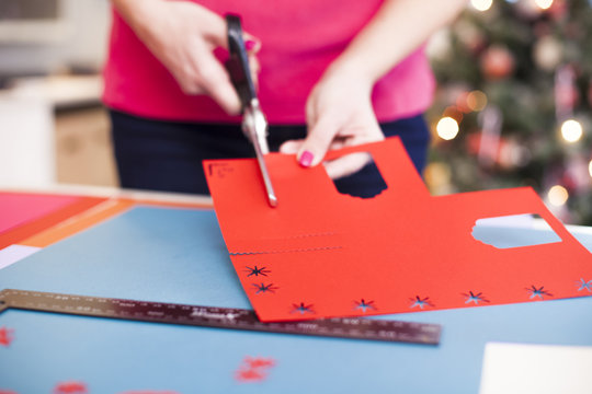 Young woman make scrapbook of the papers on the table using anti