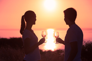 Happy couple on vacation enjoying a glass of wine. 
