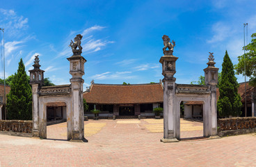 Fototapeta premium Front exterior view of Mong Phu communal house, a national relic in Duong Lam ancient village, Son Tay district, Hanoi, Vietnam.