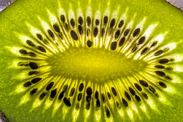 slice of kiwi fruit with seeds on a gleam