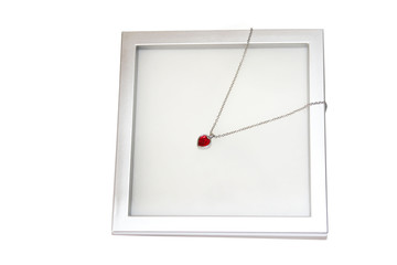 Studio shot of red jewelry heart isolated over white background.