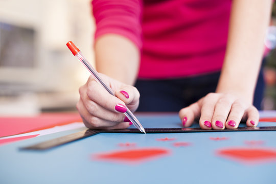 Young woman make scrapbook of the papers on the table using anti