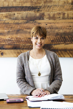 Portrait of confident businesswoman sitting in creative office