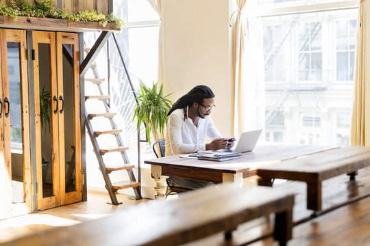 Businessman using a smartphone while working in office