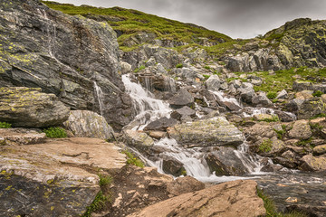 Fototapeta premium View on the waterfall from the road Trolltunga, Norway