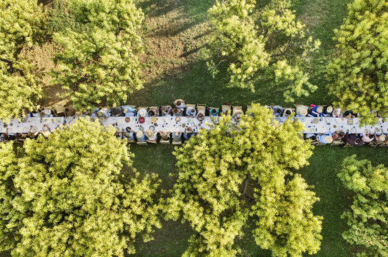 Overhead view of people having food at outdoor dining table