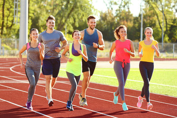 Sportsmen running at stadium