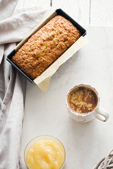 Glazed applesauce oatmeal bread on a white marble table