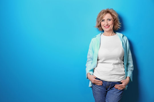 Portrait Of Beautiful Middle-aged Woman On Blue Background