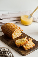Glazed applesauce oatmeal bread on a white marble table