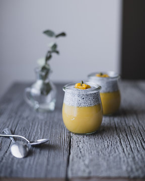 Close up of mango pudding with chia on wooden table