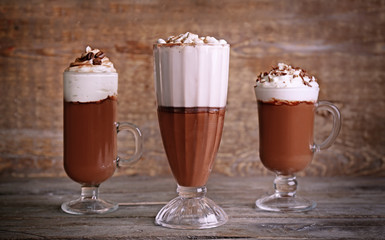 Chocolate mousse in glasses on wooden background
