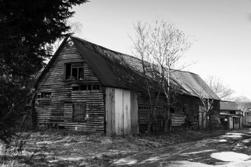 Fototapeta na wymiar Old derelict empty wooden barn in country