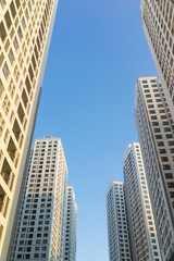 Fototapeta na wymiar Resident apartment buildings against blue sky. Real estate background