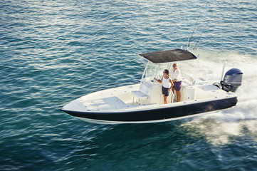 High angle view of couple driving boat on sea