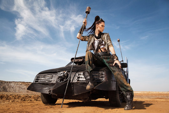 Woman warrior in futuristic clothes with car