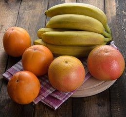 fresh fruits on wooden table, close-up.