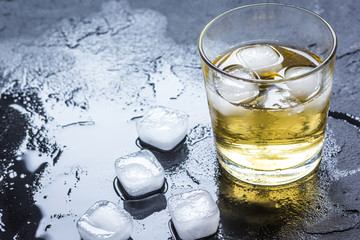 glass of whiskey on dark background