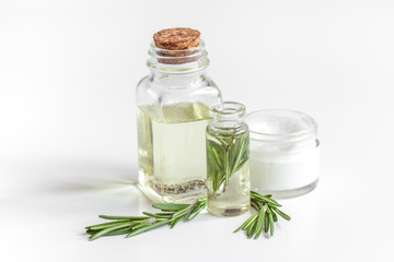 organic cosmetics with extracts of herbs rosemary on white background