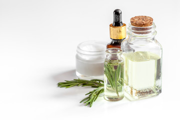 organic cosmetics with extracts of herbs rosemary on white background