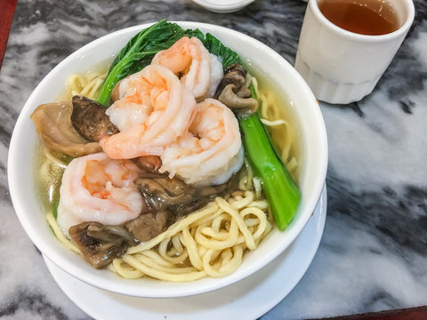 Hong kong noodle soup with shrimp, mushroom and chinese kale.