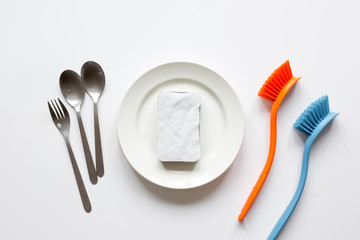 concept of washing dishes on white background top view