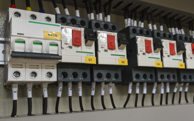 Close-up electrical wiring with fuses and contactors of machine controller.